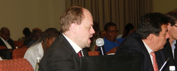 Timothy Barton interpreting at the NIPAM conference on 'Navigating the Oil Industry: Namibia seeks lesson from Venezuela'.